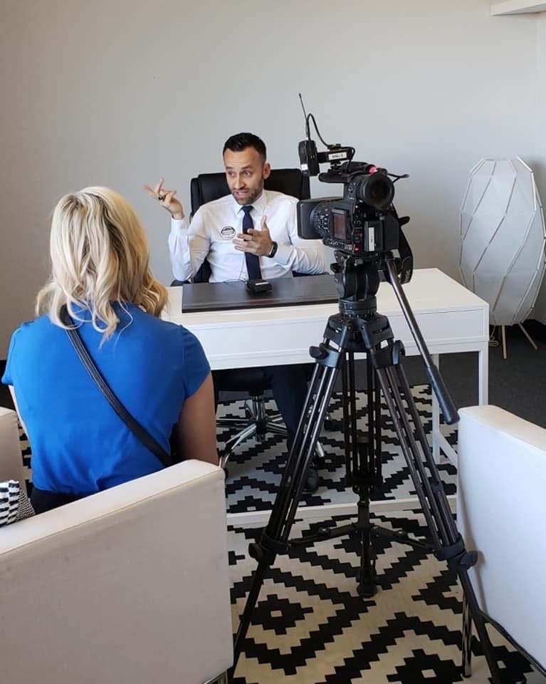 Robert Roman being interviewed by media